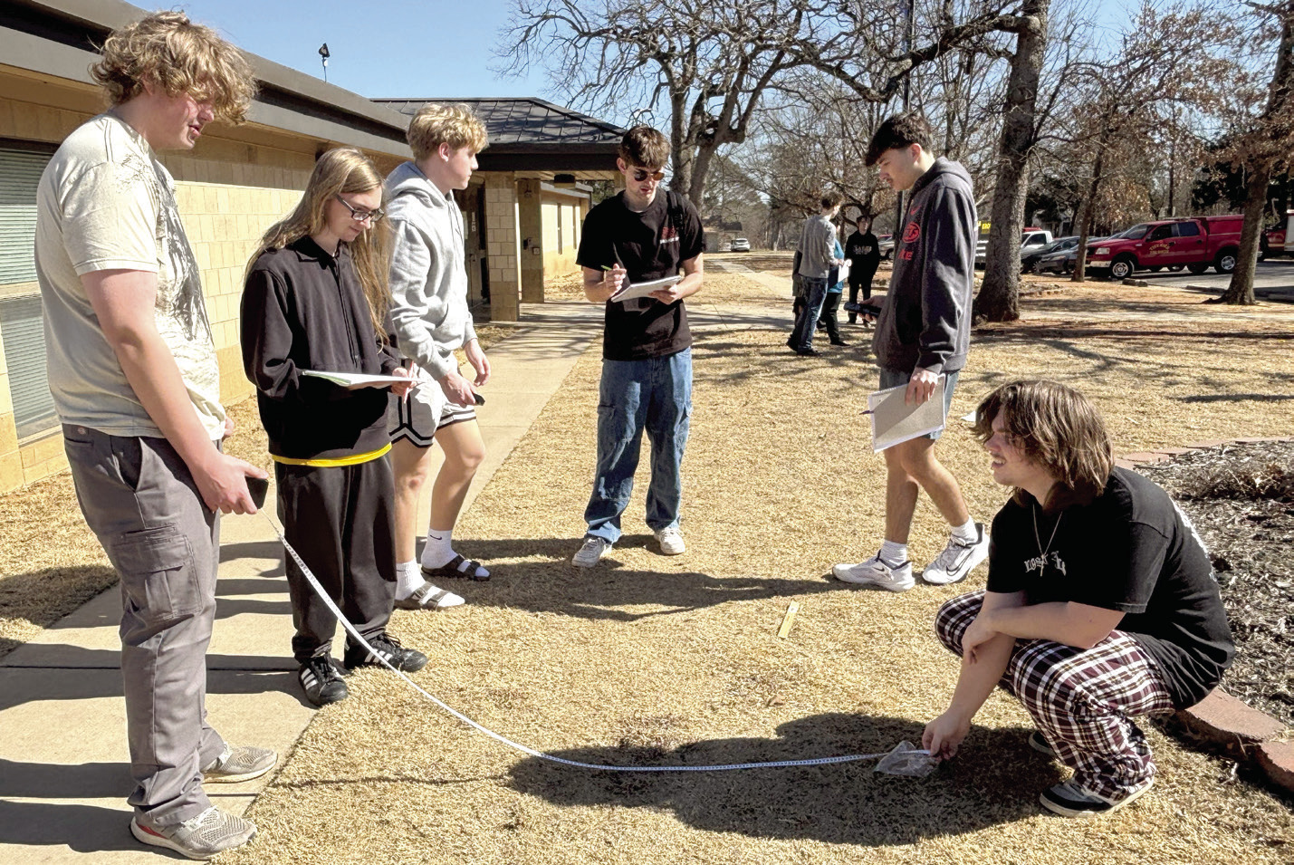Tecumseh Forensic Criminology students Jackson Lindamood, Gavin Borboa, Jace Musgrave, Wyatt Heck, Tristan Baney, and Jacob Holmes practice taking proper measurements of evidence as part of their outdoor lab. Cheyanna Dietz, THS Intern
