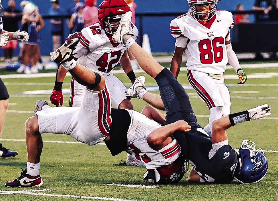 NRC's Brodie Grace stops the Harrah runner in the Sept. 11 game. Photos courtesy of Gowin Photography