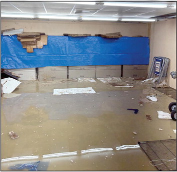 Staff works quickly to get records out of the flooded basement. Approximatey 3-5 inches of water filled the entire basement on Tuesday.