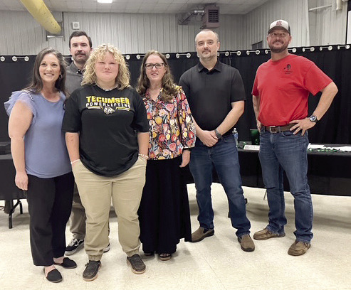 Eighth grader, Jaydi Peacock, poses with the Tecumseh School Board as they recognize her as a State Powerlifting Champion for Tecumseh Middle School. Adelaide Lack, Intern, Countywide & Sun