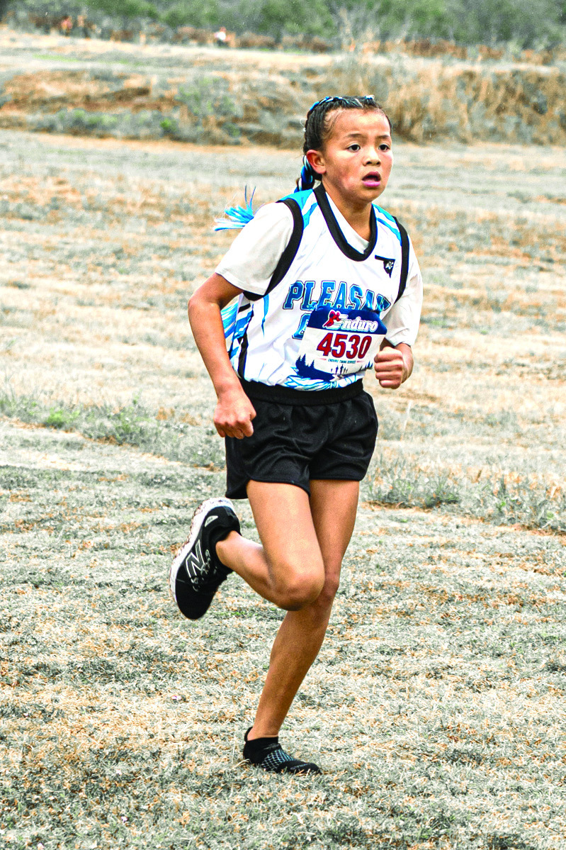 Kamryn Hobia, a 6th-grader at Pleasant Grove - Shawnee, competed in the Oklahoma Rural Elementary School Division II State Cross Country Meet on Oct 3, 2026. She ran most of the race with one shoe, losing the other shortly after the race began. She finished in first place with a time of 9:46:18, competing against 6th-8th-graders across the state. Photo provided by Adriel Clements Media