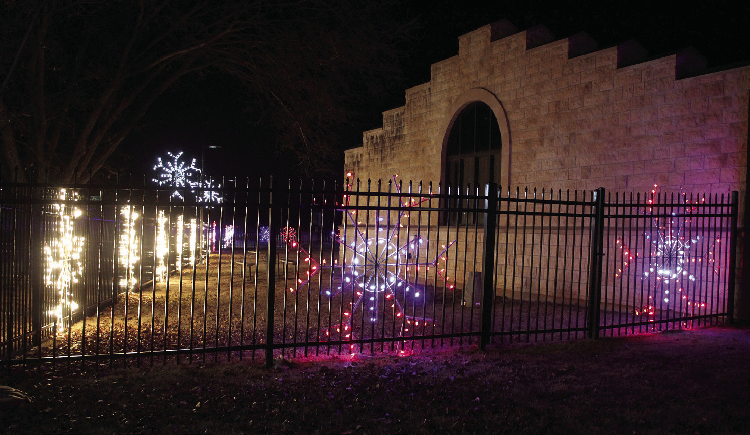 Lighted snowflakes of different colors have been refurbished by the Pottawatomie County Historical Society and are on display on the western and southern sides of the Paul and Ann Milburn Center in Shawnee. Museum Director Ken Landry said they were given 50 snowflakes from the City of Shawnee last year, and they have all but four restored. Of those, 36 are on display at the museum, and they loaned 10 to SEFF for their Santa float. 