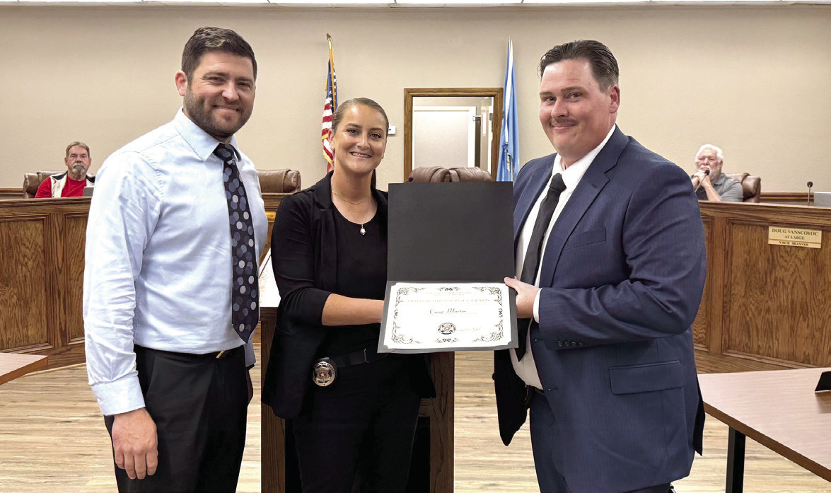McLoud Mayor Daniel McClure poses with Pottawatomie County Lieutenant Dakota Black and McLoud officer Corey Martin at the May McLoud City Council Meeting. Black presented Martin, and fellow officer Jones, with a Distinguished Service Award for their response and action during a tragic incident in April. Julie Talton, Countywide &amp; Sun