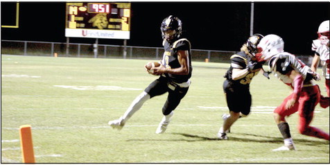 Tecumseh junior Marquan Krush runs the ball - as Conner Barksdale keeps a McLoud player at bay - for a touchdown in the second quarter of the Homecoming game on Sept. 16. The Tecumseh Savages won 40-14. Countywide &amp; Sun/Natasha Dunagan