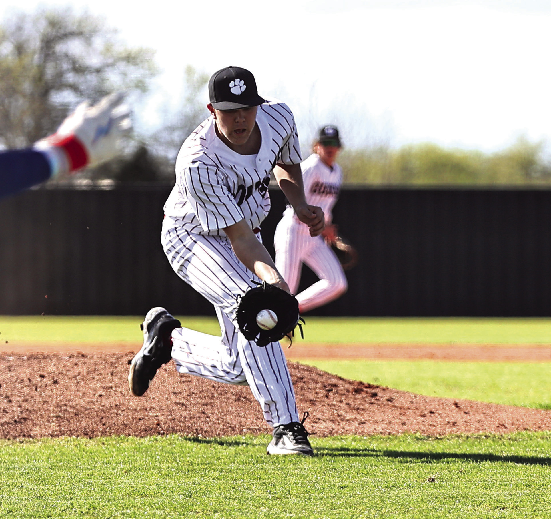 North Rock Creek’s Jace Plumb gets the ball hit back to him and makes the throw to first for the out.