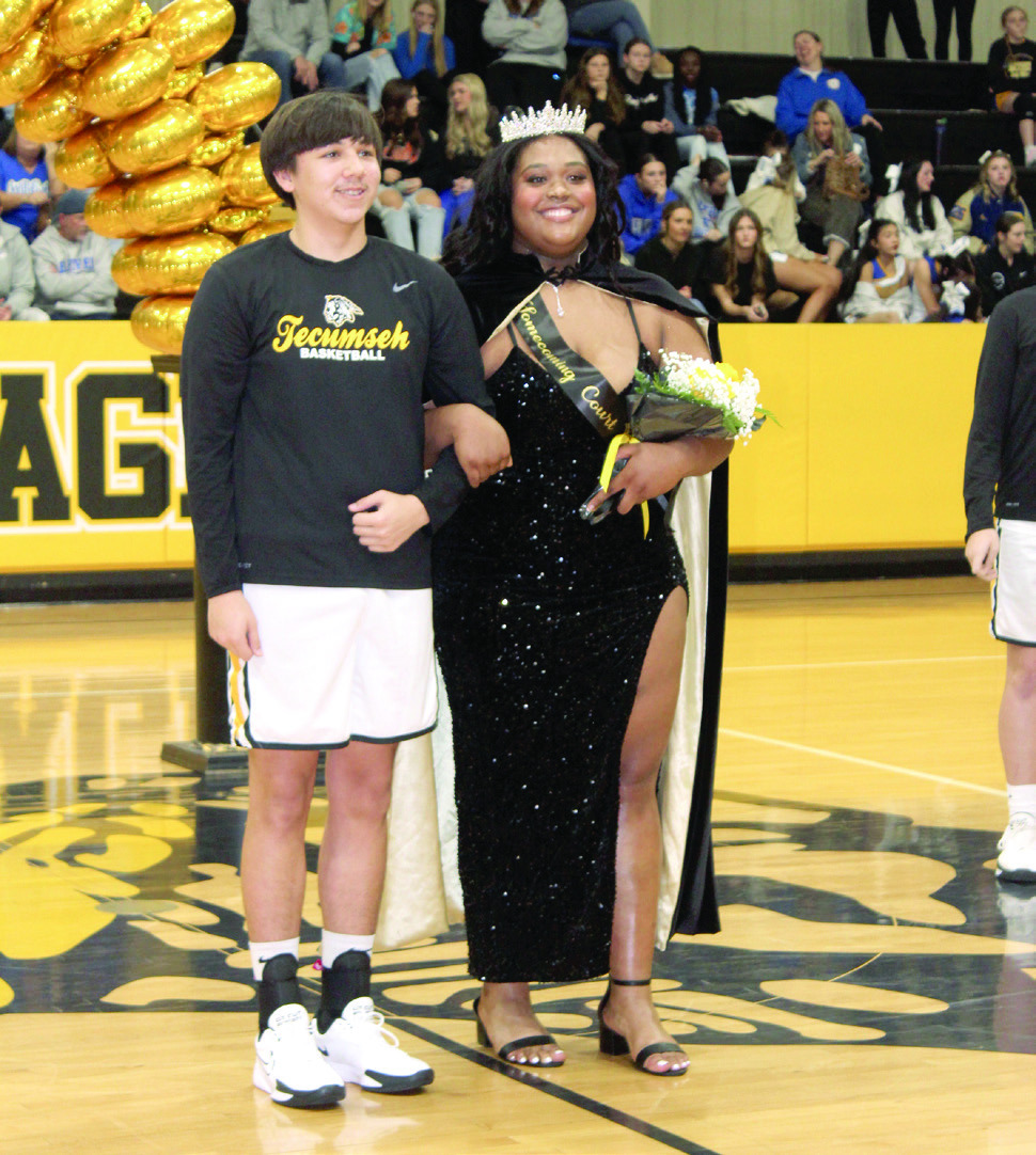 Queen Kiara Stallin is escorted by junior Sampson Martin after being crowned during the Tecumseh High School Spring Homecoming on Feb. 7. File photo
