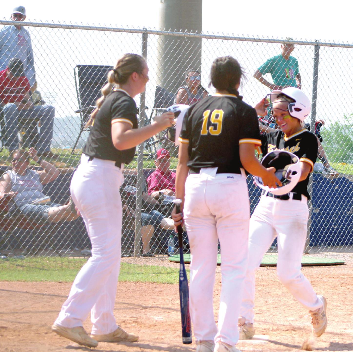 Tecumseh senior Lauren Taylor taps helmets with her teammates after she hit a home run in the third inning of the Class 5A State Tournament Quarterfinal game against Stilwell, held at the USA Softball Hall of Fame on May 9. The Lady Savages slow-pitch softball team won, 14-8, but they fell in the Semifinals, 1-5, to Perkins-Tryon that same day. They end their season with a record of 29-8. Countywide &amp; Sun/ Natasha Dunagan