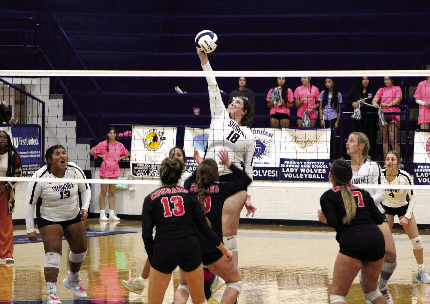 Shawnee’s Dalaney Vranga (#18) returns the ball over the net, as teammate Kanynn Kaseca (#13) cheers her on, during the home match against North Rock Creek on Sept. 19. The NRC Cougars won 3-0 (2518, 25-13, 25-10). Countywide &amp; Sun/ Natasha Dunagan