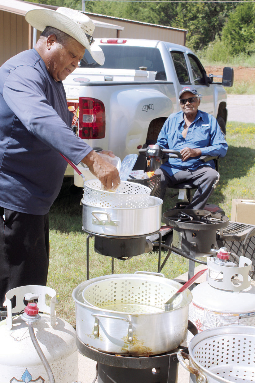Frank Phillips batters and fries catfish outside the Brooksville Community Center, as his brother Leonard Phillips watches, during a fish fry fund-raiser on Aug. 23. Phillips caught about 150 pounds of catfish for the fund-raiser, which benefitted a new restroom at the Brooksville Cemetery. So far, the framework has been built for the restroom, and Brooksville Mayor Charles Carthen said, in addition to mens' and womens' restrooms, it will have a sitting area. 
