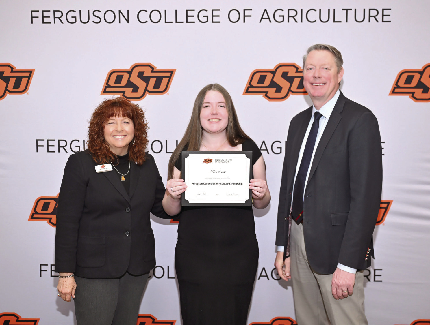 Cynda Clary, associate dean for academic programs and Jayson Lusk, dean for the Ferguson College of Agriculture, present Elle Scott with a scholarship Photo provided by OSU