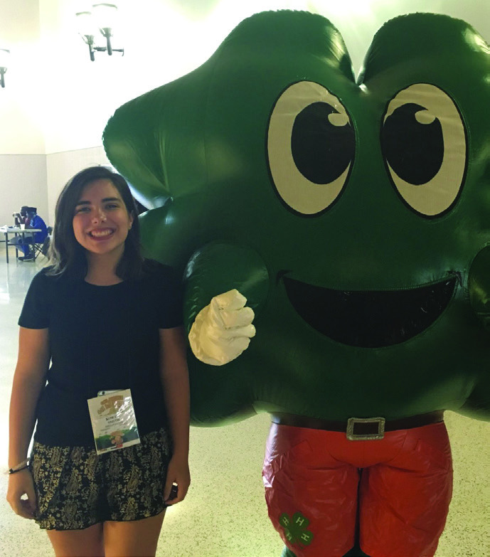 McLoud 2018 graduate Kortni Perkins poses with the 4-H mascot during the 2017 Oklahoma 4-H State Roundup. Photo provided