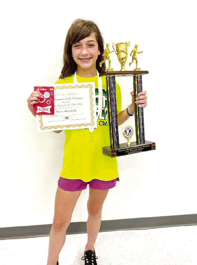 Fifth-grader Bree Mitchell, of South Rock Creek, poses with her Golden Trackshoe trophy and certificate after winning three Division II events in Kiwanis Little Olympics on May 12. Photo provided.