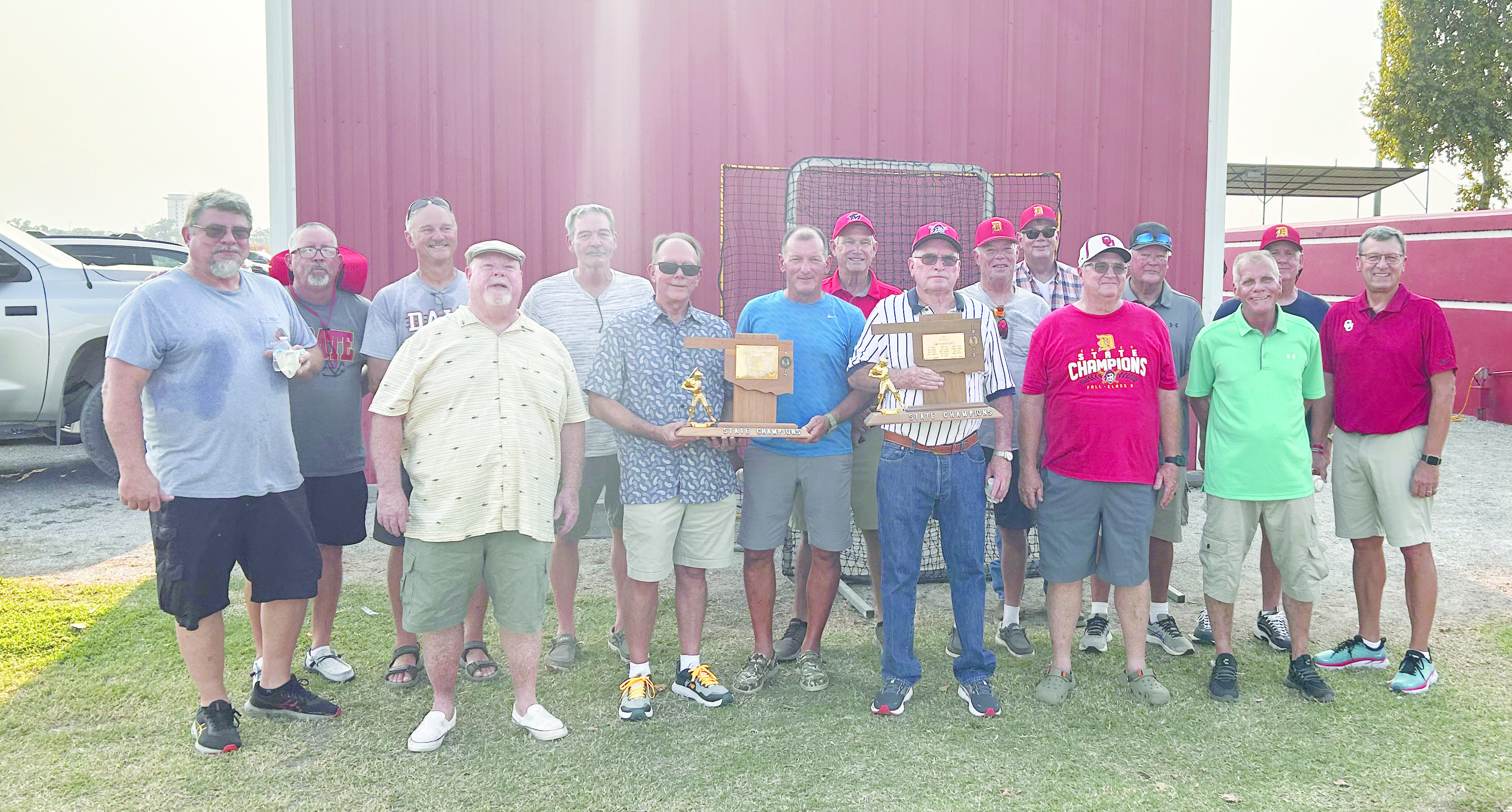 Coach Washburn is pictured with the trophies and members of the 1975 and 1979 State Championship teams and maybe a younger player or two. Countywide & Sun/Suzie Campbell