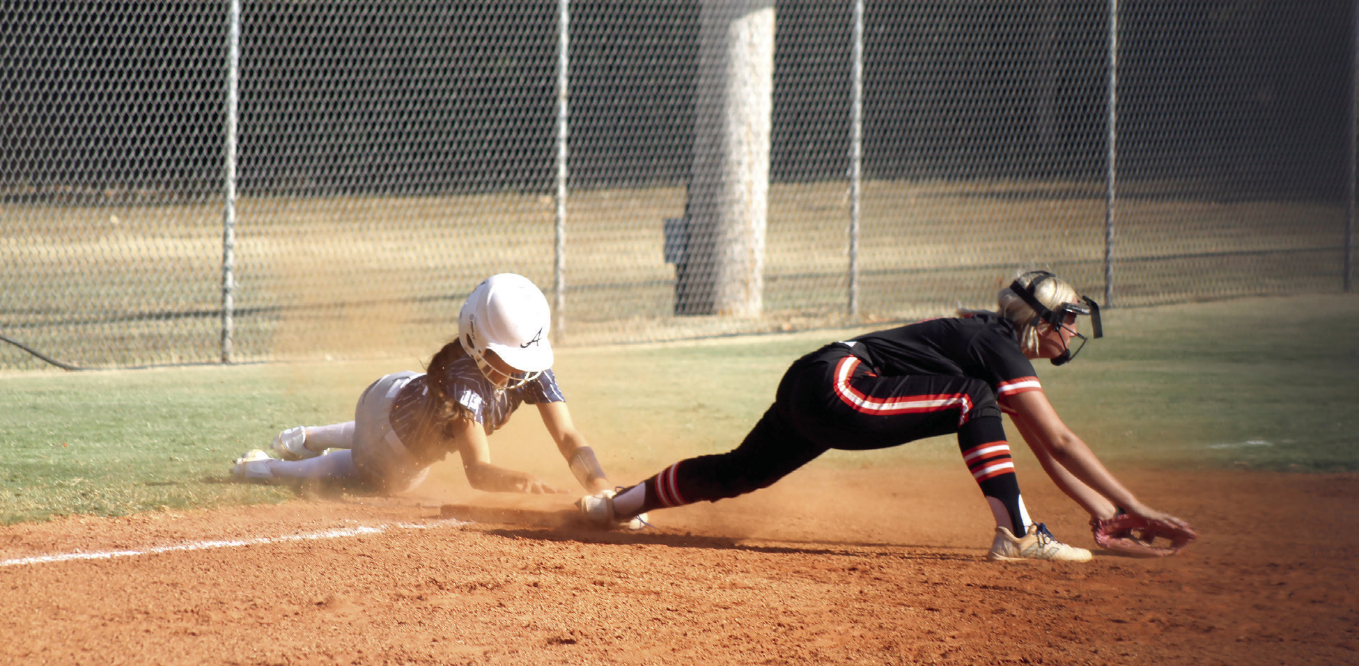 Asher sophomore Amaya McFerran holds onto the base after stealing third, as her Carney counterpart comes up empty for the catch in the first inning of the Aug. 20 home game. McFerran stole home shortly after this. The Lady Indians won 12-2, and have a record of 5-1 so far. They are hosting a fast pitch tournament today (Aug. 27) through Saturday.