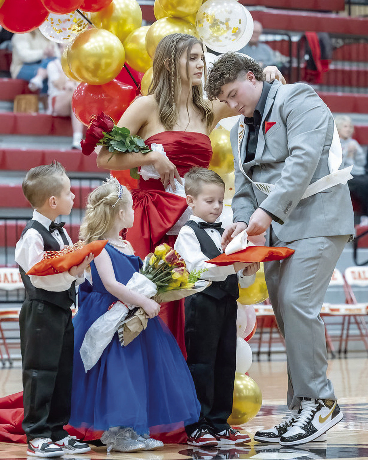 Dale Homecoming Queen Grace Anderson fixes the jacket collar of King Elijah Millette while he removes her sash from the pillow. Also pictured are twin boys Legend and Nolan Radford and carrying the flowers is Eastyn Cantrell. Photo courtesy of Richelle Treece