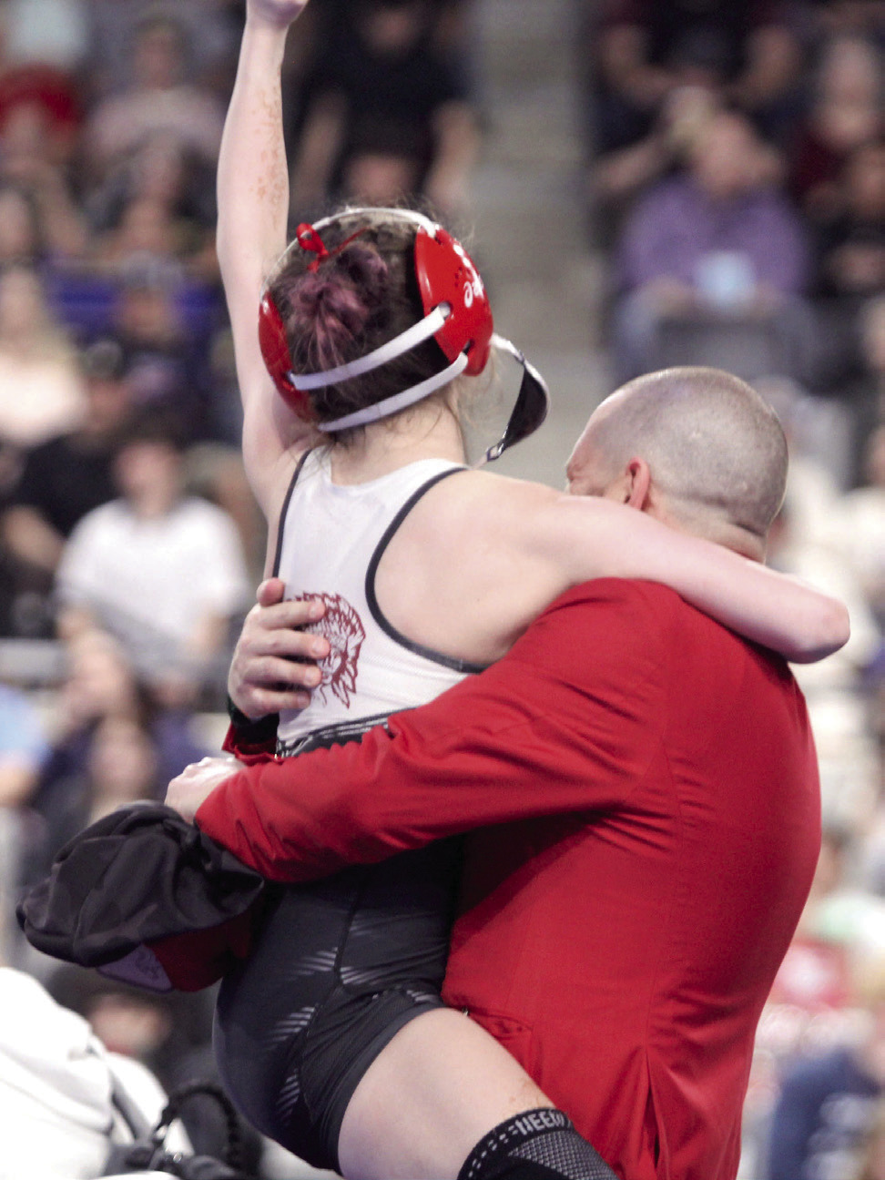 McLoud's Remy Whitney jumps into her dad's/coach's arms after winning her State Final match on Feb. 28. Her father, Coach Chad Whitney, was also named Class 5A Girls Coach of the Year, making them the fourth father-daughter duo in state history to both win individual state titles, according to Oklahoma Wrestling.