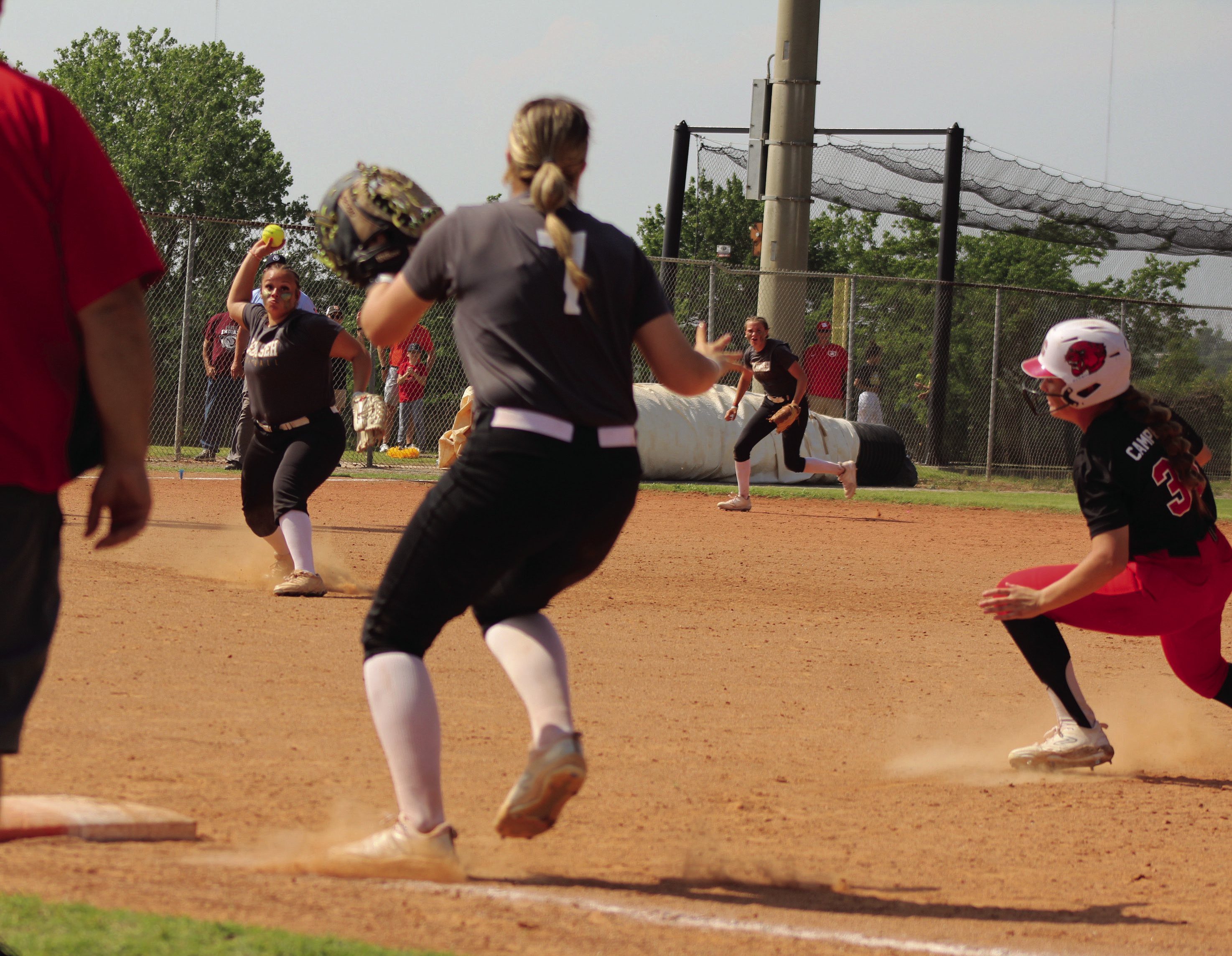 Tecumseh pitcher Khylei Daniels throws to first-baseman Samantha Schweighardt to get the third out in the bottom of the seventh inning and win the Class 5A State Semifinals against North Rock Creek on April 30. Last year, Tecumseh also played NRC during the semifinals and lost, 13-18. This year, they won, 13-7. 