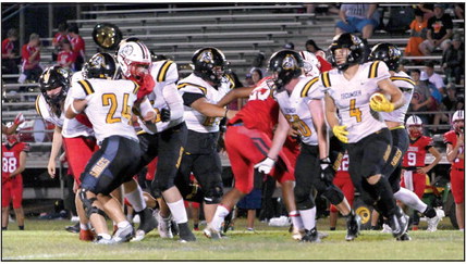 Tecumseh senior Ross Griggs (#4) breaks away from the pack to run the ball in the away game at McLoud on Sept. 15. The Savages won, 26-13. Photo provided by Kenetta Lisenbee.