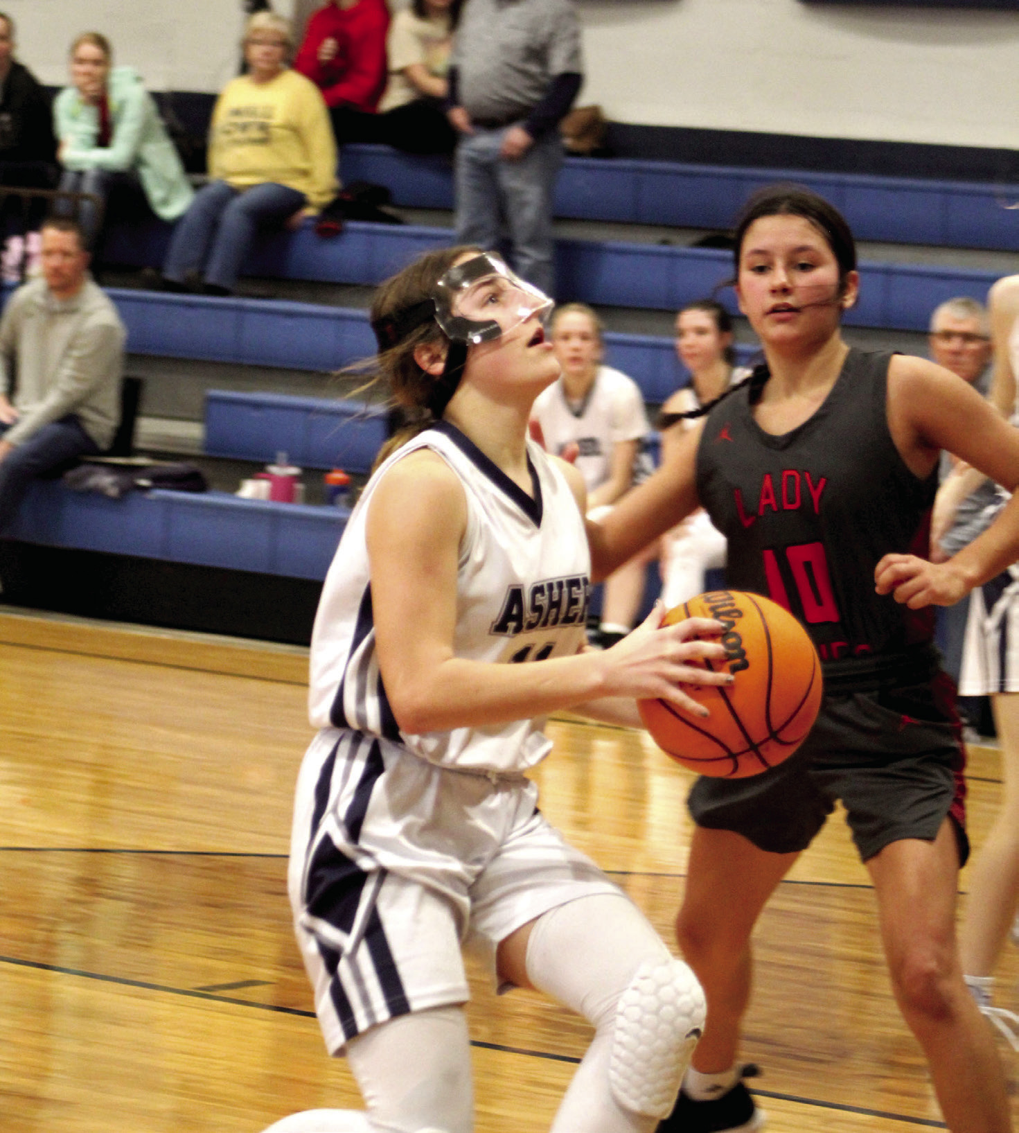 Asher’s Cadence Leba aims before making two points, as Macomb’s Aubree Akens guards, during the Asher home game on Jan. 28. The Asher Lady Indians won, 47-15. Countywide &amp; Sun/Natasha Dunagan