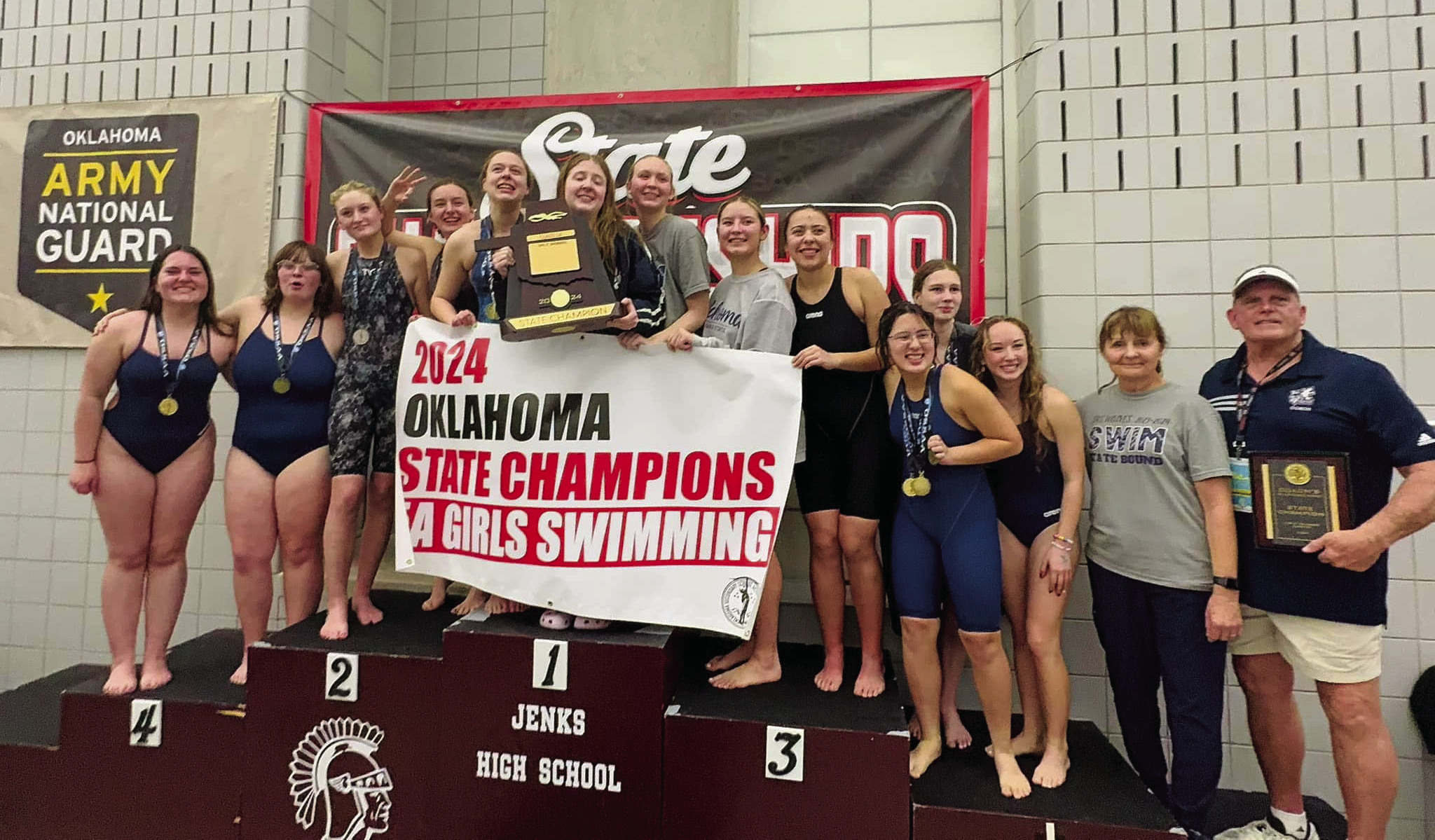 Despite the many hurdles created by the April 2023 tornado, the Shawnee Girls Swim team pushed their way to a third straight State Championship. The team posed for a quick photo with the newest banner. Photo provided