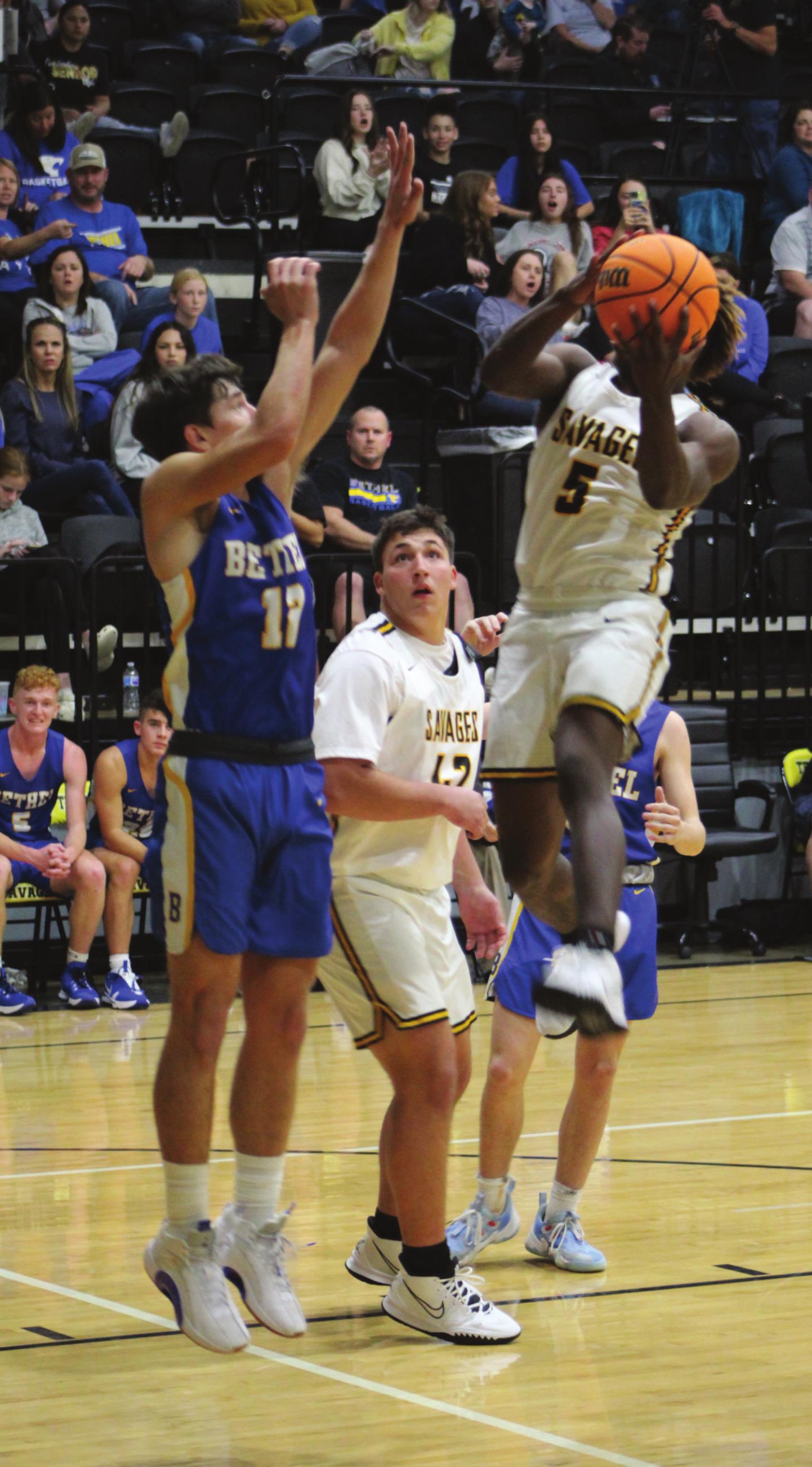 Tecumseh’s Daveon Mays makes a basket as Bethel’s John Gordon plays defense during the Tecumseh home game on Dec. 3. Bethel won 77-56. Countywide &amp; Sun/Natasha Dunagan