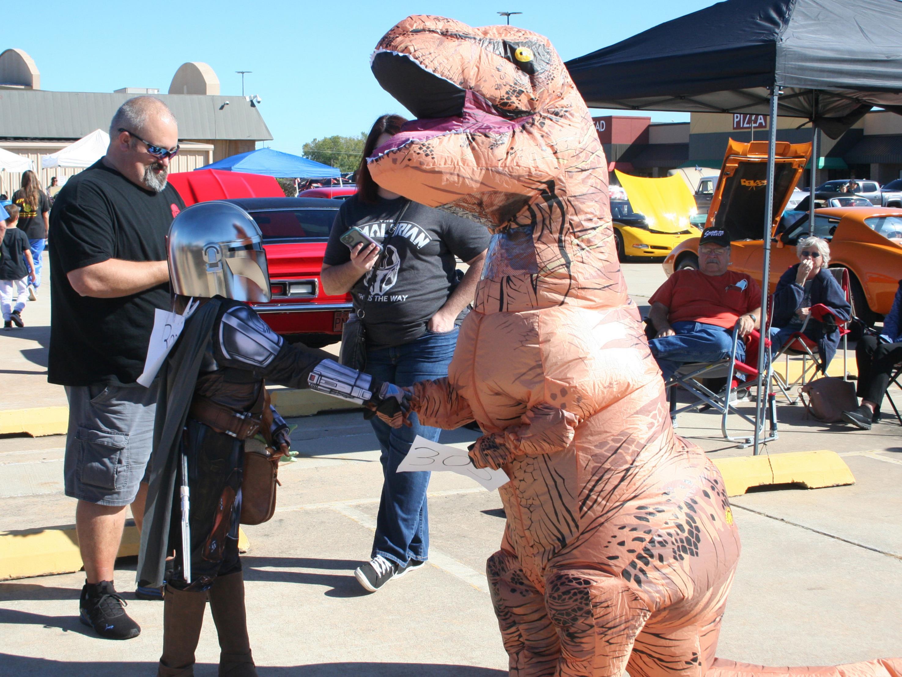 Eleven-year-old Colby Duroy (right) shakes hands with a fellow costume contest contestant dressed as the Mandalorian, while gathering for the contest. The costume contest took place at the 17th Annual FireLake Casino Car Show, Oct. 16. See more photos on page B7. Countywide &amp; Sun/Kendra Johnson