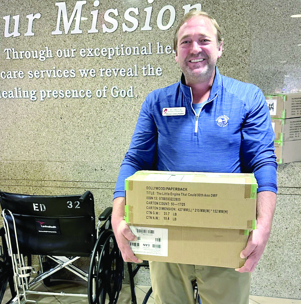 The Pioneer Library System Foundation donated another 1,000 Dolly Parton Imagination Library books to SSM Shawnee!! Pictured is Will Merrick, PLSF Development Officer, “This delivery represents what’s best about our community — people coming together to make sure every child has the chance to dream big, learn early, and grow strong.” Photo Provided