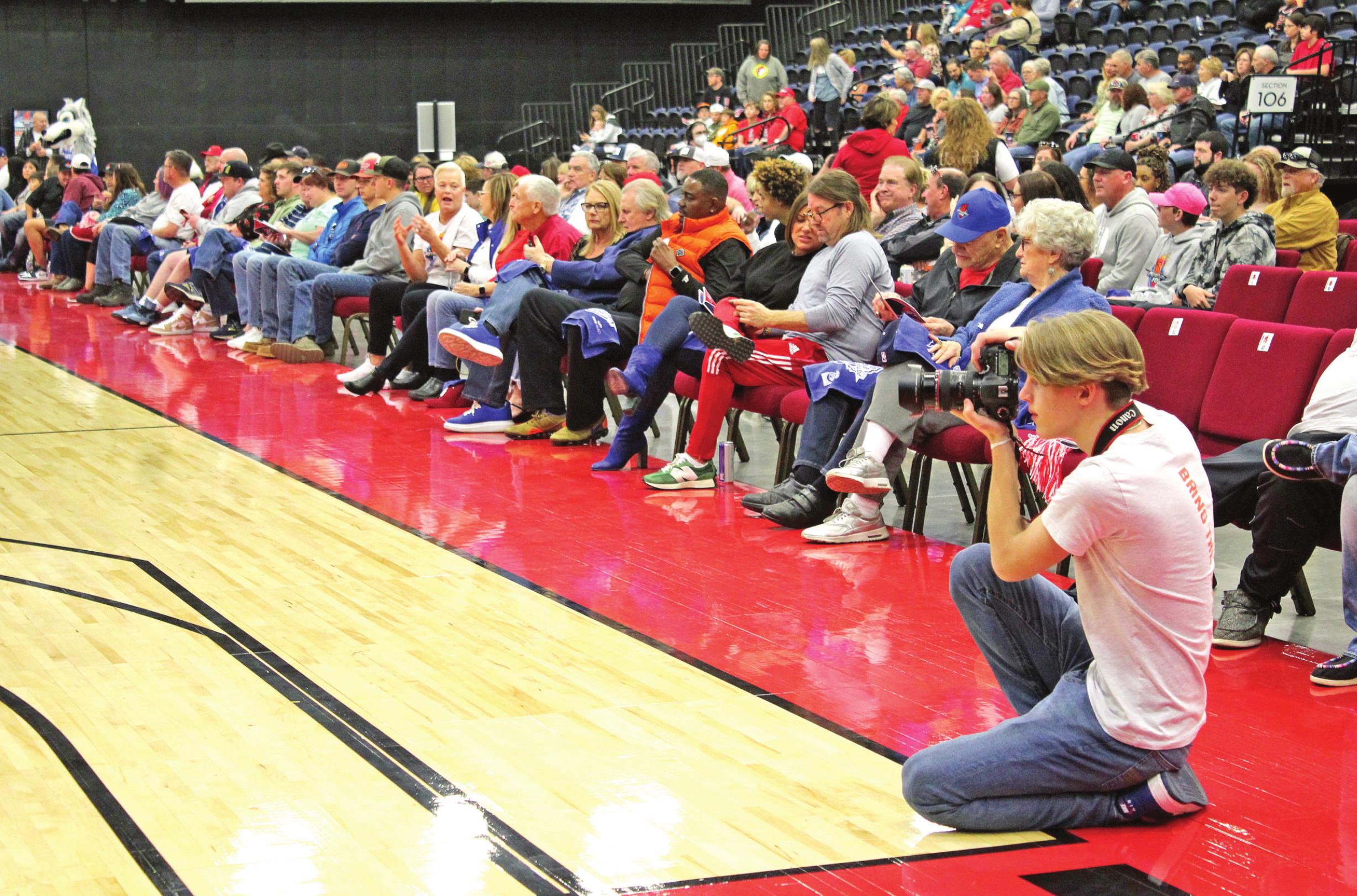 Landon Kidney takes action shots from one corner of the court at the Potawatomi Fire's first home game on March 19.