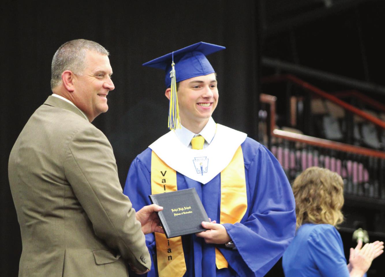Bethel President of the Board of Education David Elmore presents Valedictorian Brady Gardner with his high school diploma on May 21. Bethel graduated 63 seniors this year.