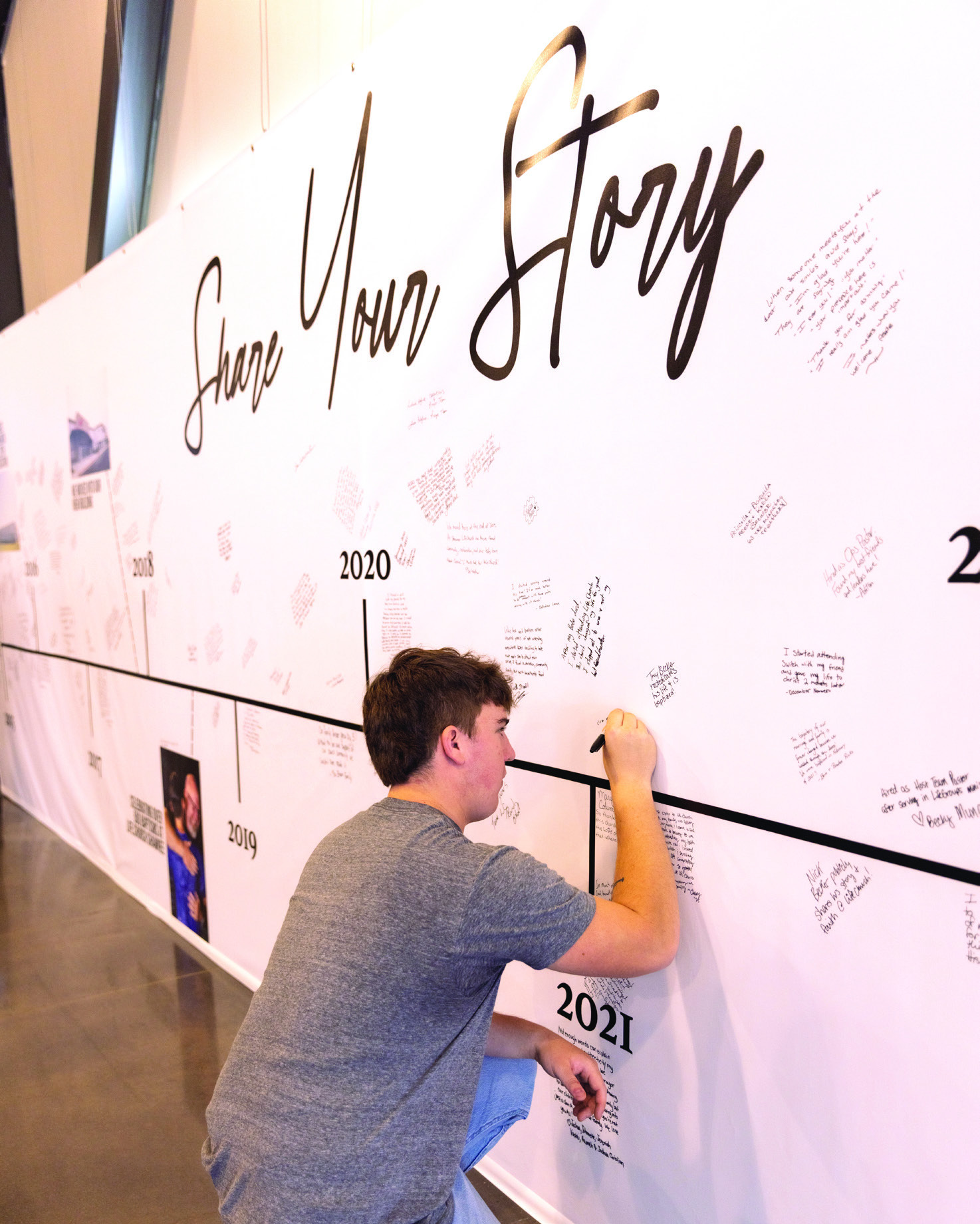 Members of Life.Church add their story to the 10 year4 timeline wall during the anniversary celebration. Photo provided
