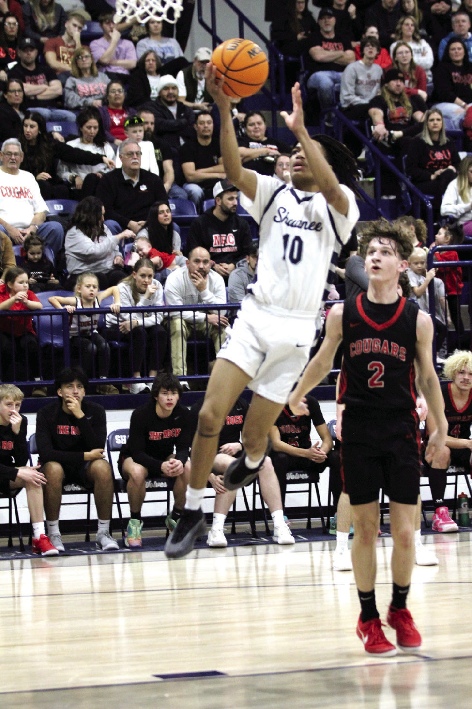 Shawnee senior Zyron Campbell makes a bucket as North Rock Creek junior Kohen Warden looks on during the Feb. 8 game at Shawnee. The Wolves lost, 53-61. Countywide & Sun/Natasha Dunagan
