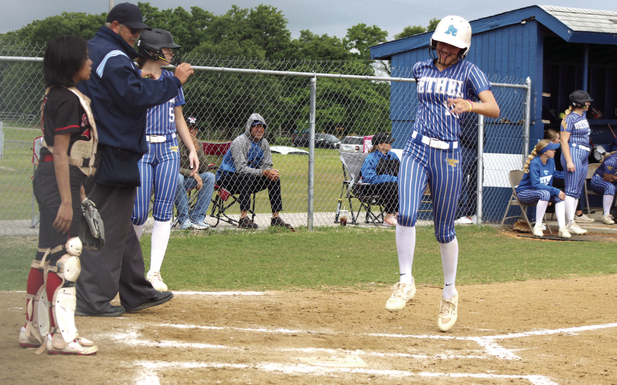 Bethel senior Layla Menhusen runs across the plate for a home run during the first home game against Okmulgee in the Class 5A District Slow Pitch Tournament on April 23.