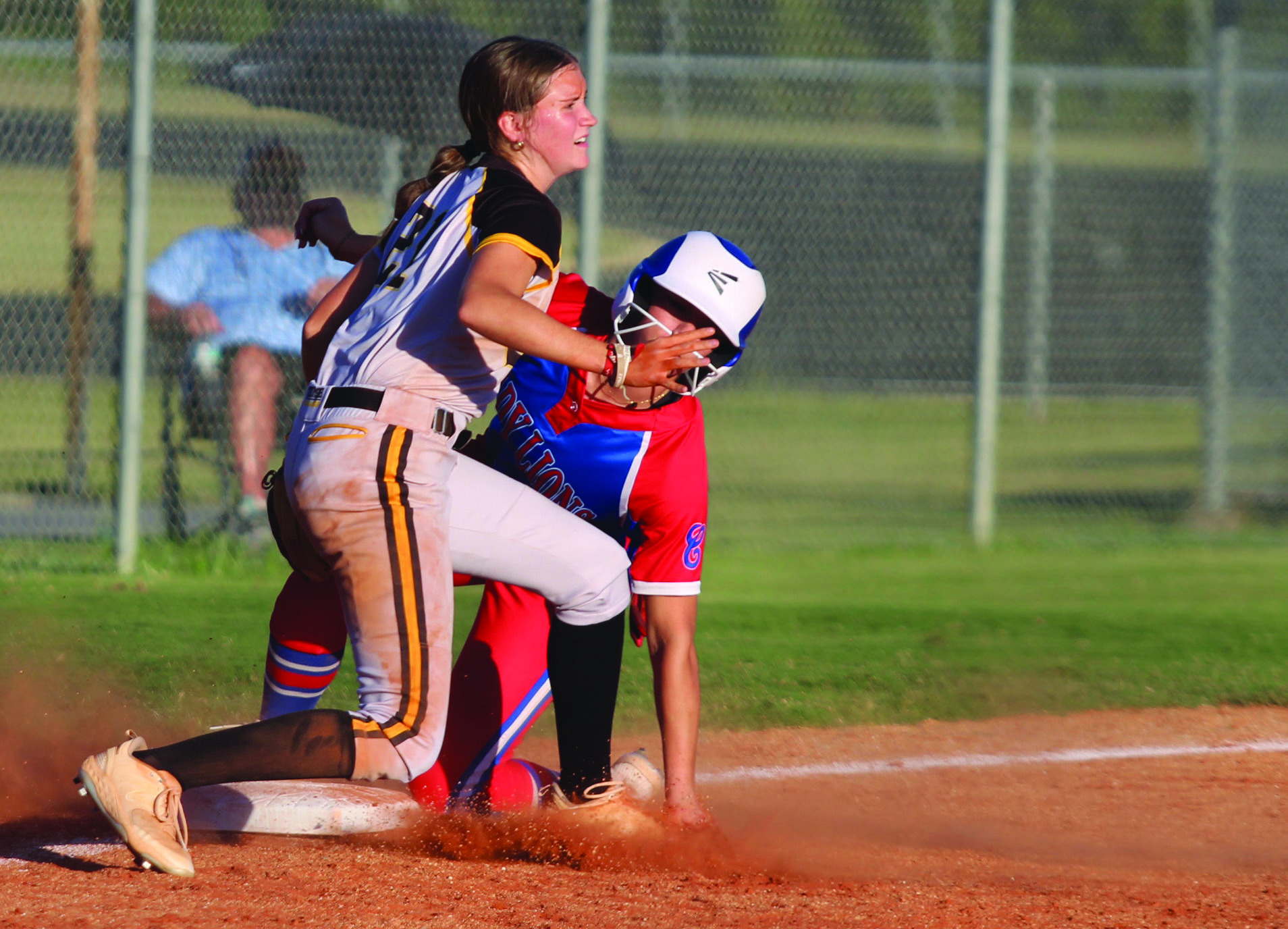 Tecumseh sophomore Madison Gray tries to protect third base as a Lady Lion slides onto it during the sixth inning of the Sept. 30 home game with Chandler. The Lady Savages won, 3-2. Countywide &amp; Sun/Natasha Dunagan