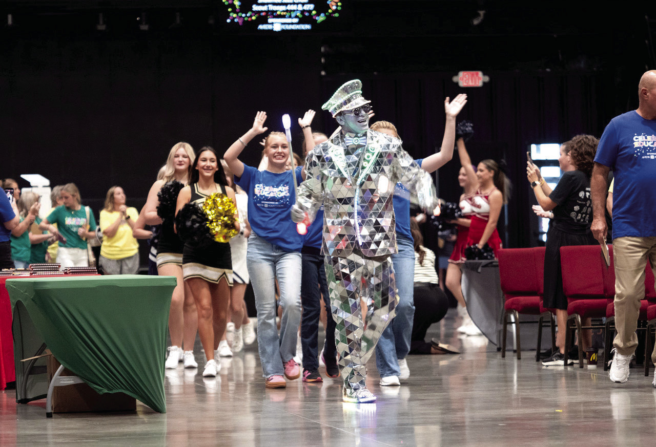 Entertainer “The Mirror Man” leads a processional of area students and a drum line into the Firelake Arena. Photo courtesy of Jesse Monday