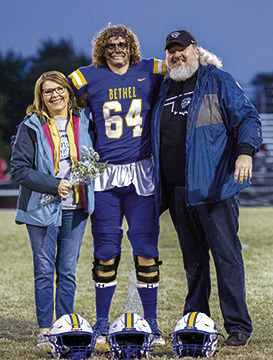 Carla and Thomas Tollett pose with their Bethel senior, Alex Tollett, during Senior Night ceremonies before the home football game on Oct. 28. Photo provided by Richelle Treece.