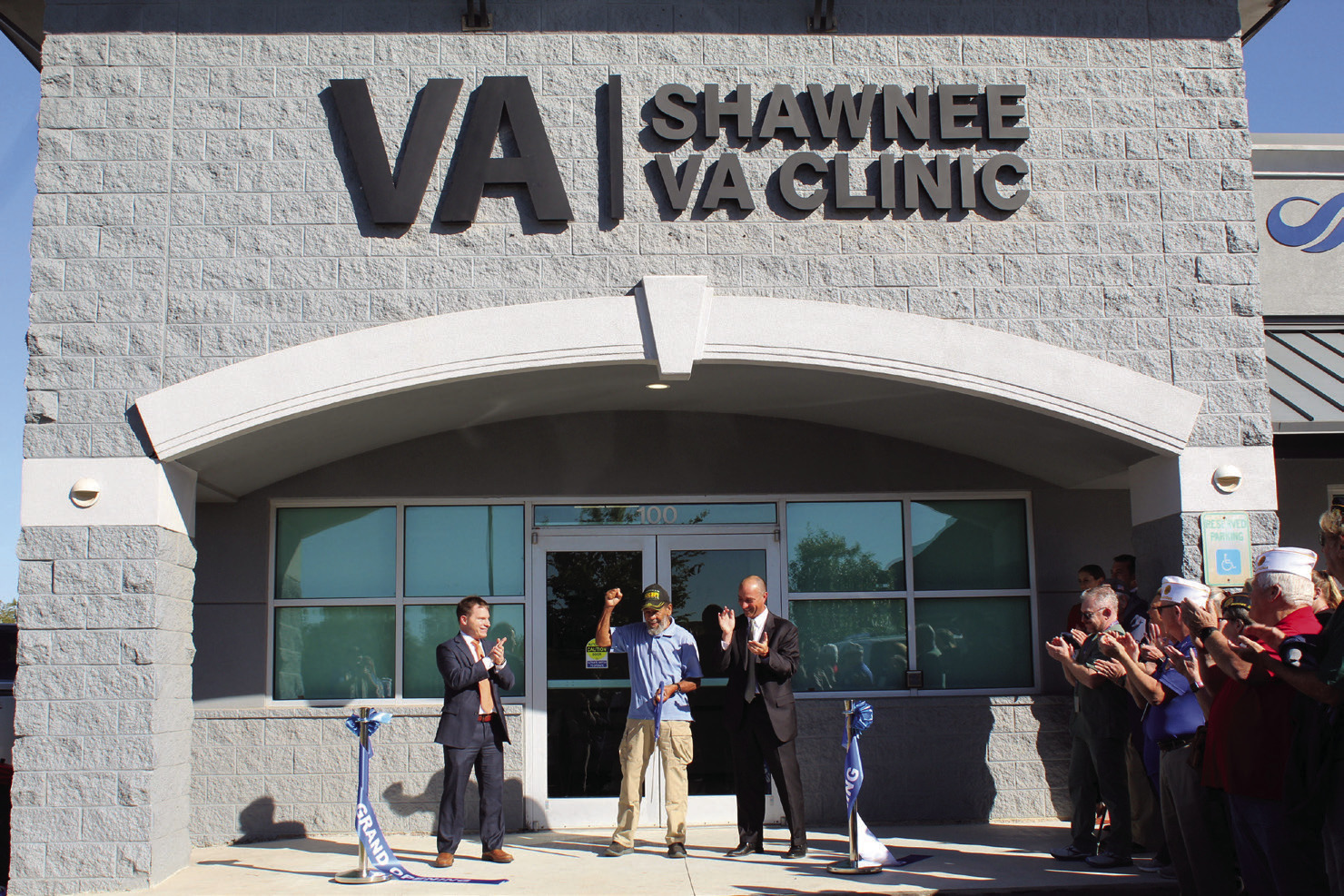 Everyone applauds after Vietnam Navy Veteran Lawfton Edwards cuts the ribbon for the Shawnee VA Clinic during the Grand Opening on Oct. 21. Also shown are OKC VA Healthcare Systems Associate Director Paul Gregory, left, and Director Wade Vlosich, right, as well as several other veterans. Countywide &amp; Sun/Natasha Dunagan