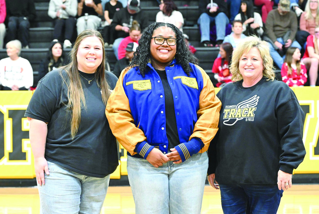 Tecumseh High School 2025 graduate Kiara Stallin received her All-State Track jacket during the homecoming games on Jan. 30. Also shown are former track coach Montana Palmer, left, and Track and Cross-Country Coach Kortney Ozment. Photo courtesy of Kenetta Lisenbee