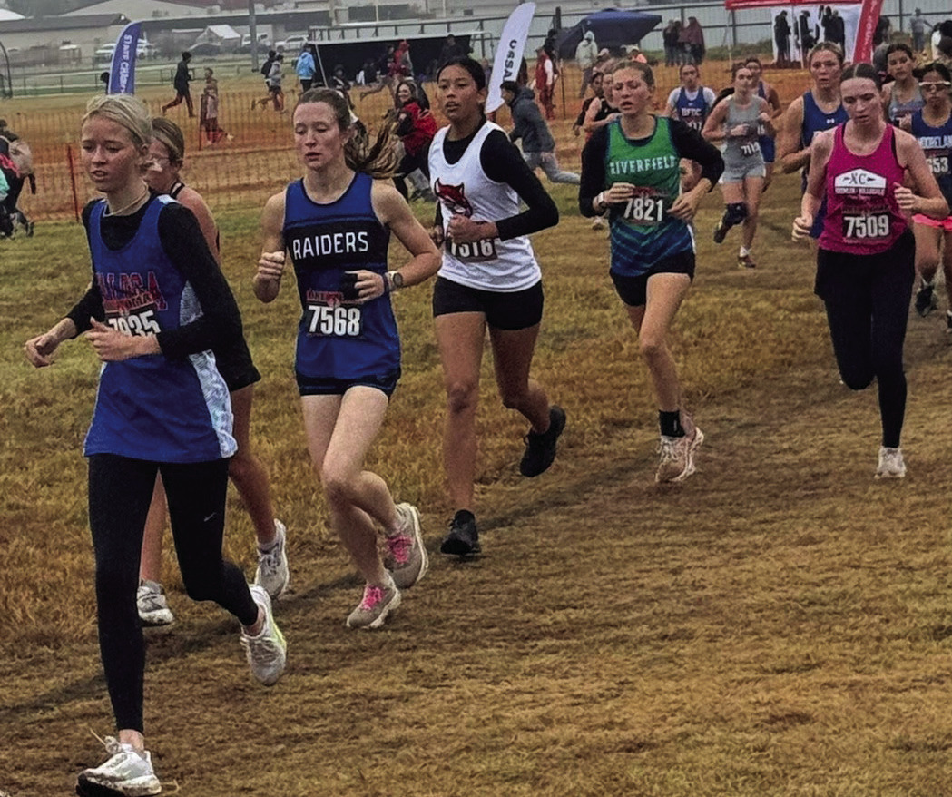 Earlsboro Junior Aha Roubidoux (white jersey) runs in the State Cross Country Track Meet hosted by North Rock Creek on Oct. 25. Photo Provided