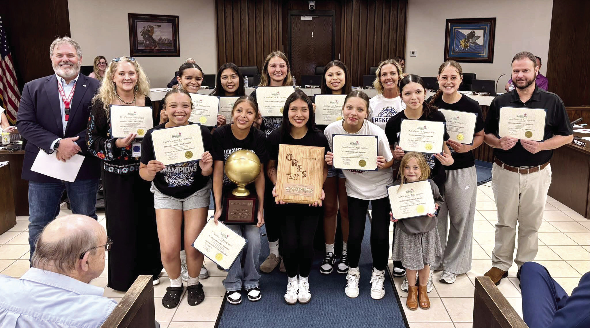 The Pleasant Grove Lady Warriors Three-time Basketball Champions were recognized at the Shawnee City Commission meeting April 20. Back row: Mayor Stephens, Sally Thomason, Syniah Grayson, Chulve Roubioux, Kerrigan Wootten, Laila Shields, Coach Wootten, Coach Tramble and Bryan Guthrie. Front row: Brylee Cosby, Devyn Arriaga, Clarissa Lena, Jada Pleets, Anessa Hamon and Collins Wootten. Not pictured: Alize Zidor and Coach Lambert Photo Provided