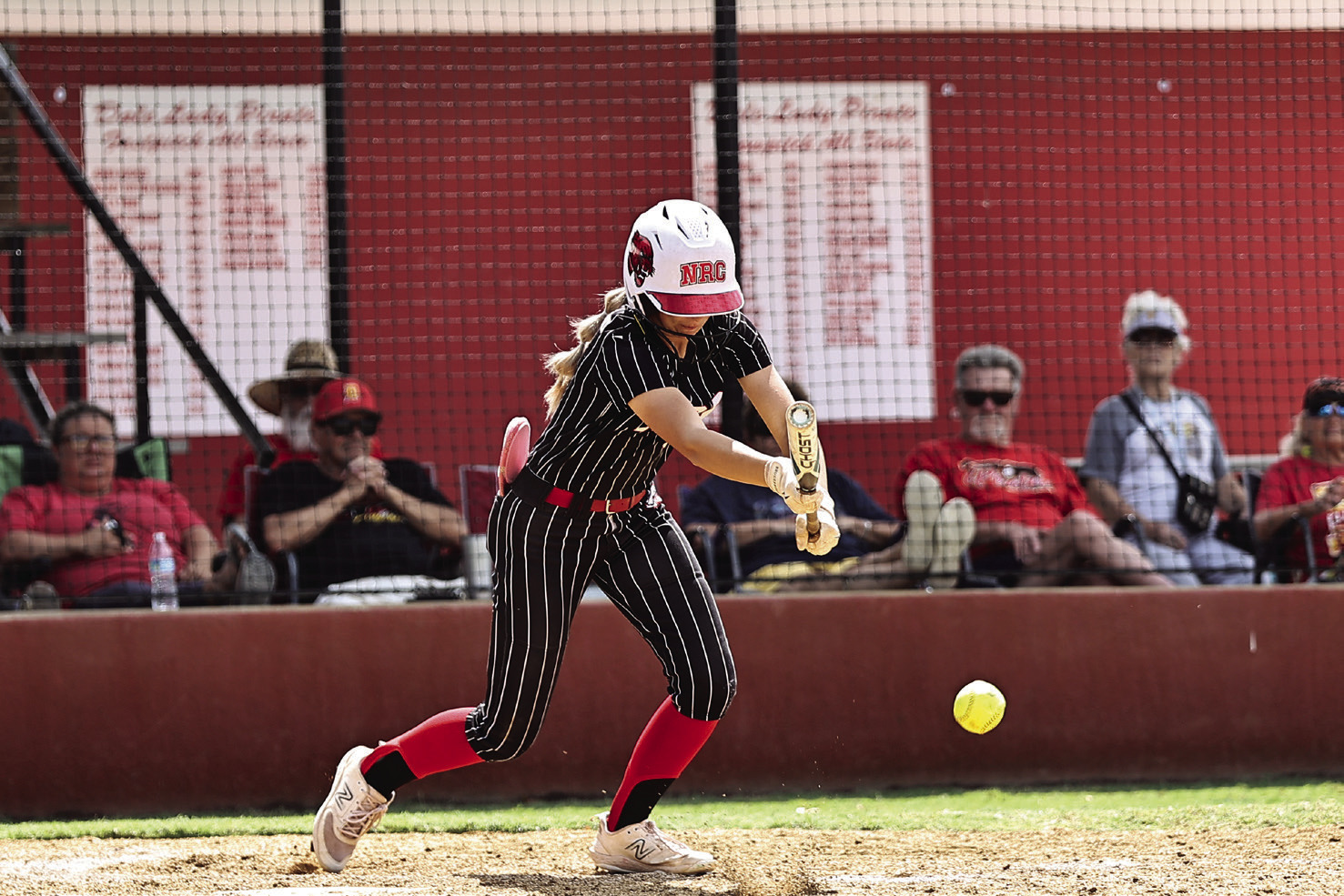 North Rock Creek’s Aubree Shivelhood lays down a bunt in action Friday. Photo courtesy of Gowin Photography