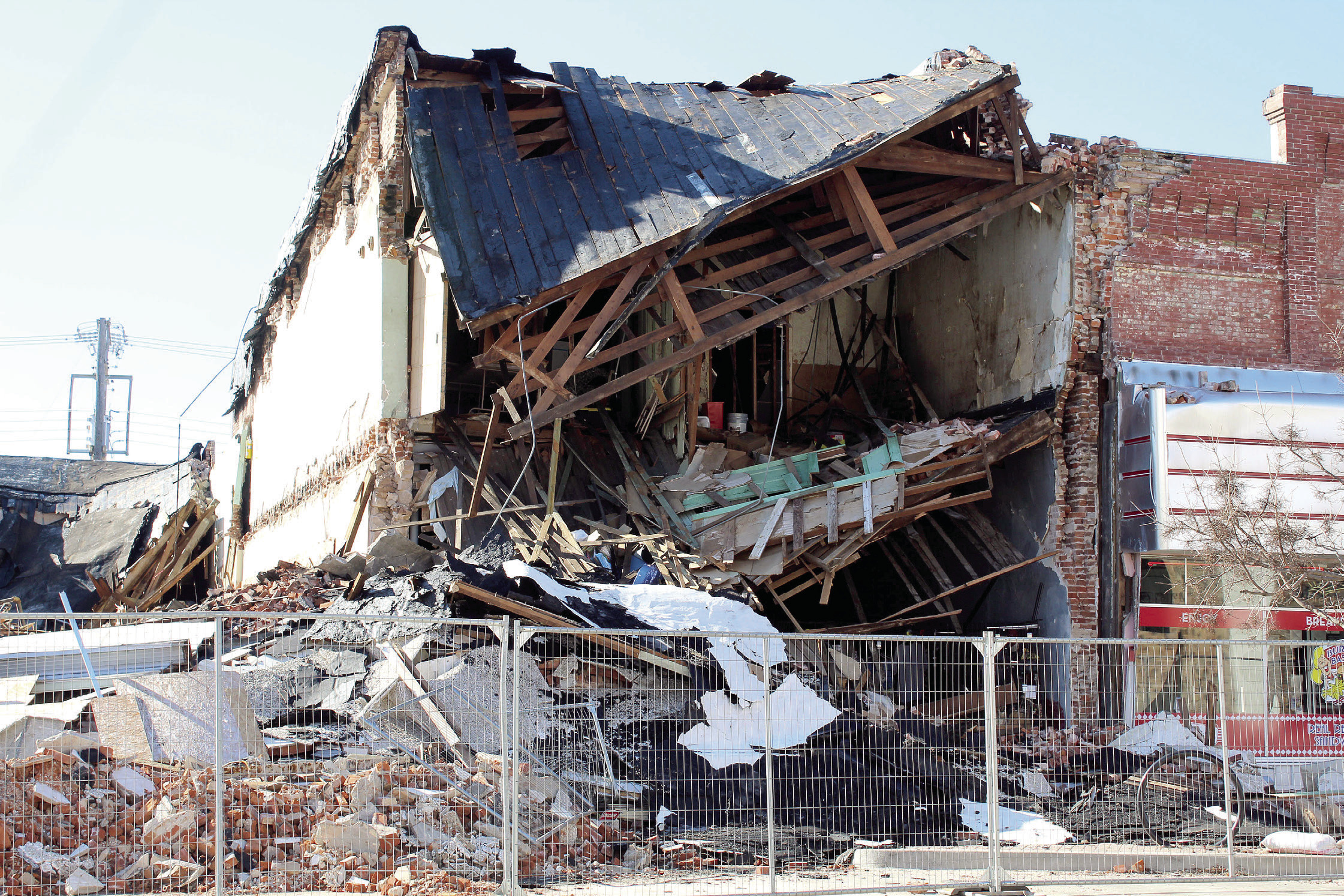 The Past to Present Marketplace stands in rubble after its neighboring building on the corner of Broadway and Main was demolished on Jan. 24. One of its co-owners was decorating inside the front windows when the demolition began and left before the building collapsed. Countywide & Sun/Natasha Dunagan