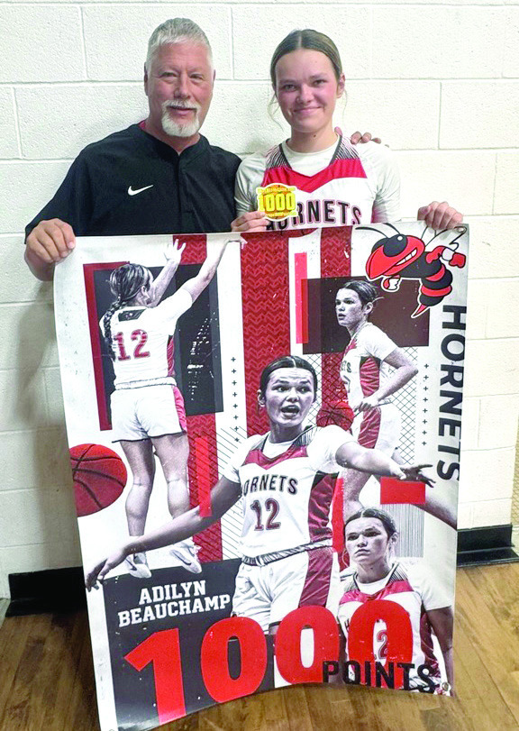 Macomb sophomore Adilyn Beauchamp achieved her 1,000th point on Jan. 30 in the game against Butner. She is shown here with Head Coach James Hancock. Photo provided