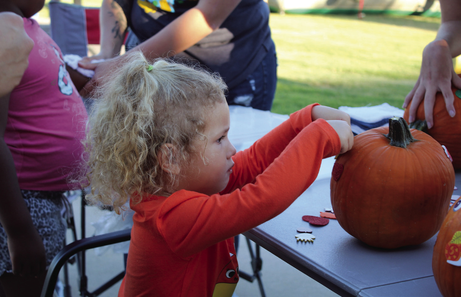 Emery Thomas, 2, of Bethel, decorates a pumpkin with stickers during the Frenzy on Federal Oct. 1. Countywide &amp; Sun/Natasha Dunagan