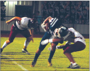 Shawnee sophomore Dace Shaw puts his shoulder into escaping a tackle during the home game against Blanchard on Sept. 16. The Wolves lost 13-40. Countywide &amp; Sun/Natasha Dunagan