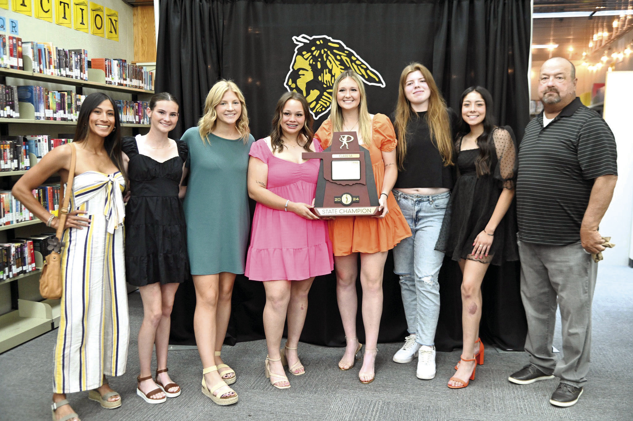Tecumseh Slow Pitch Assistant Coach Kayla Rodriguez, Lady Savage seniors Chloe Stephenson, Laney Sanders, Khylei Daniels, Sami Schweighardt, Reagan Berry and Serenity Jacoway and Head Coach Perry Wilson pose with their Class 5A Slow Pitch State Championship trophy during the Tecumseh High School Athletic Awards on May 13. Photo provided by Kenetta Lisenbee.