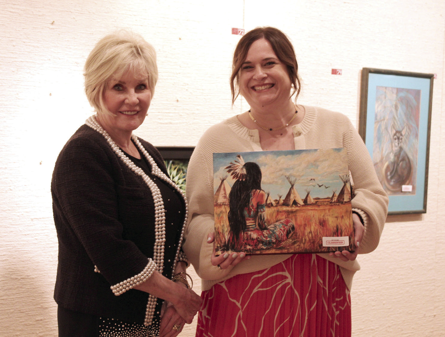 Artist Marcia Crook poses with Amanda Johnson, after Johnson chose her artwork, at the annual "Off the Wall" event at the Mabee-Gerrer Museum of Art on April 24. See full cutline below.