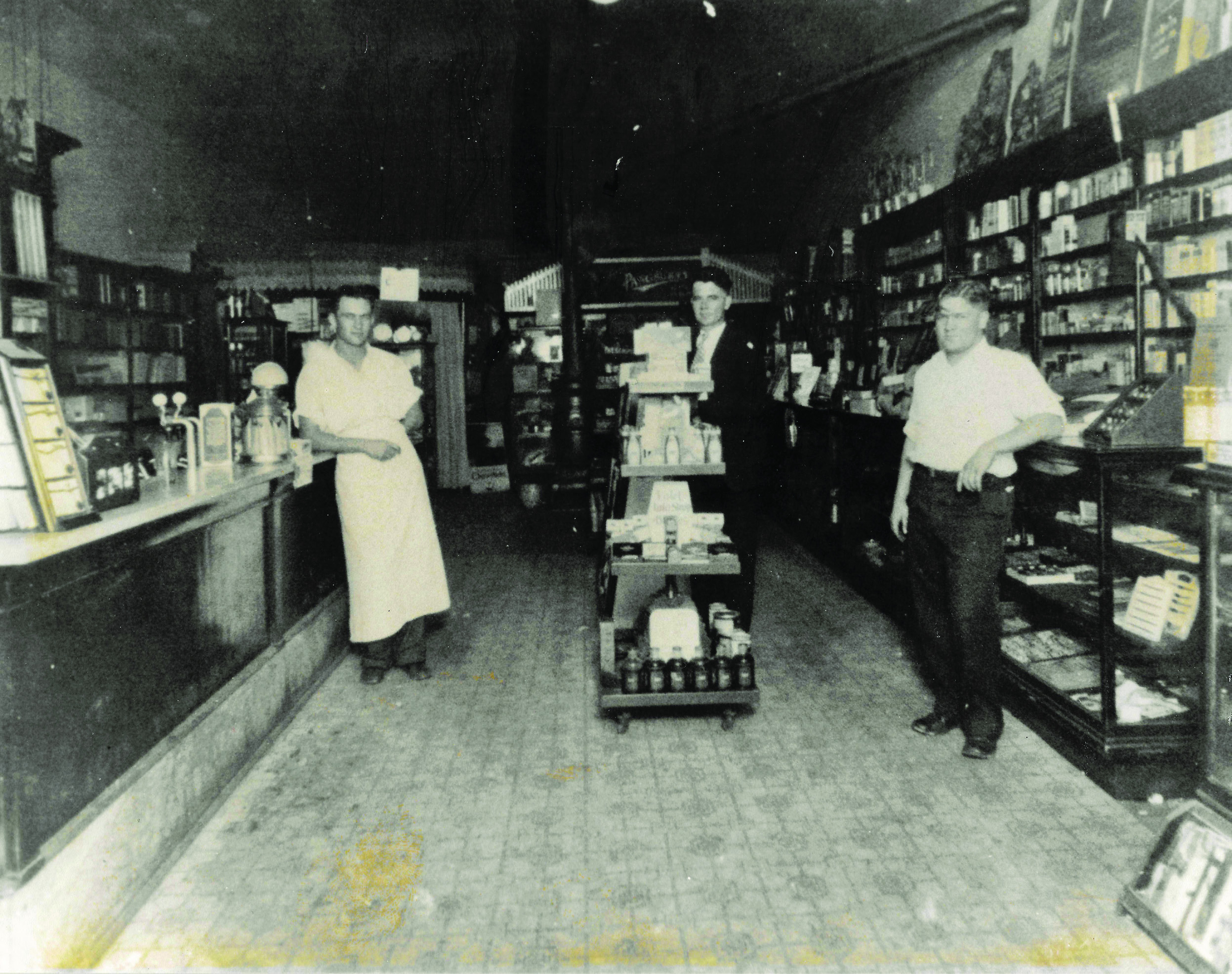 Inside Lisle Drug, approximately 1917, A.C. Lisle, Sr. (center) poses with a couple of friends. Photo provided by McLoud Historical Society