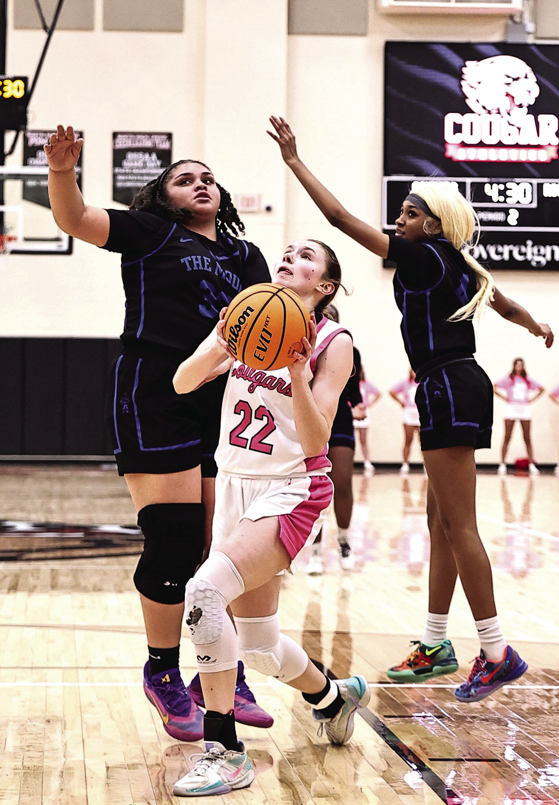 Kadence Munn goes between two defenders to add two in her 24-point game total against Mount St. Mary on Feb. 3. NRC won the home game 60-38. Photos Provided by Gowin Photography