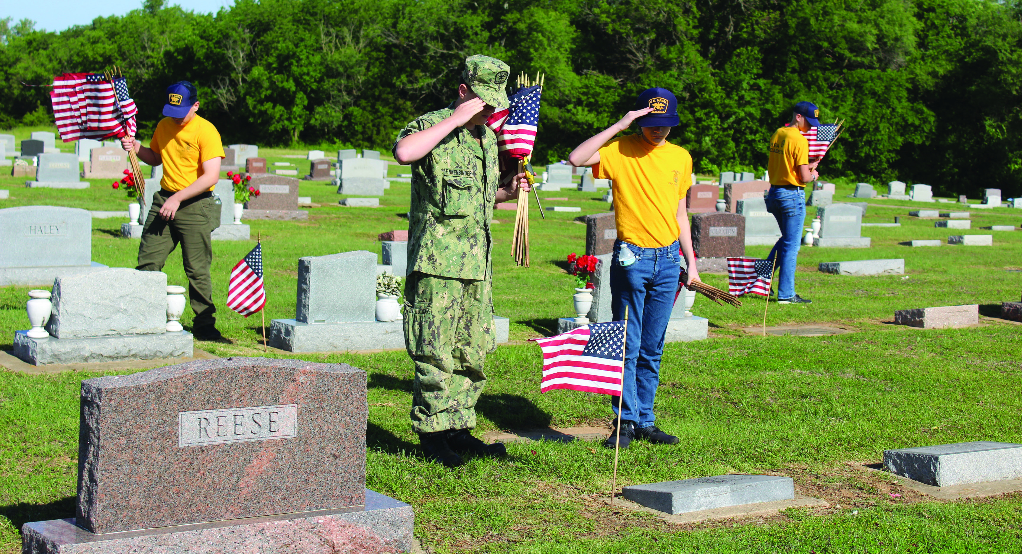 U.S. Naval Sea Cadets SN Zane Finkenbinder and Recruit Carver Conkling salute the grave of WWI veteran William Garsee, as SR Mehmet Akkus, far left, and SR Zackery Henderson look for more veterans' graves at Tecumseh Cemetery on May 17. See full cutline below. Natasha Dunagan, Countywide & Sun