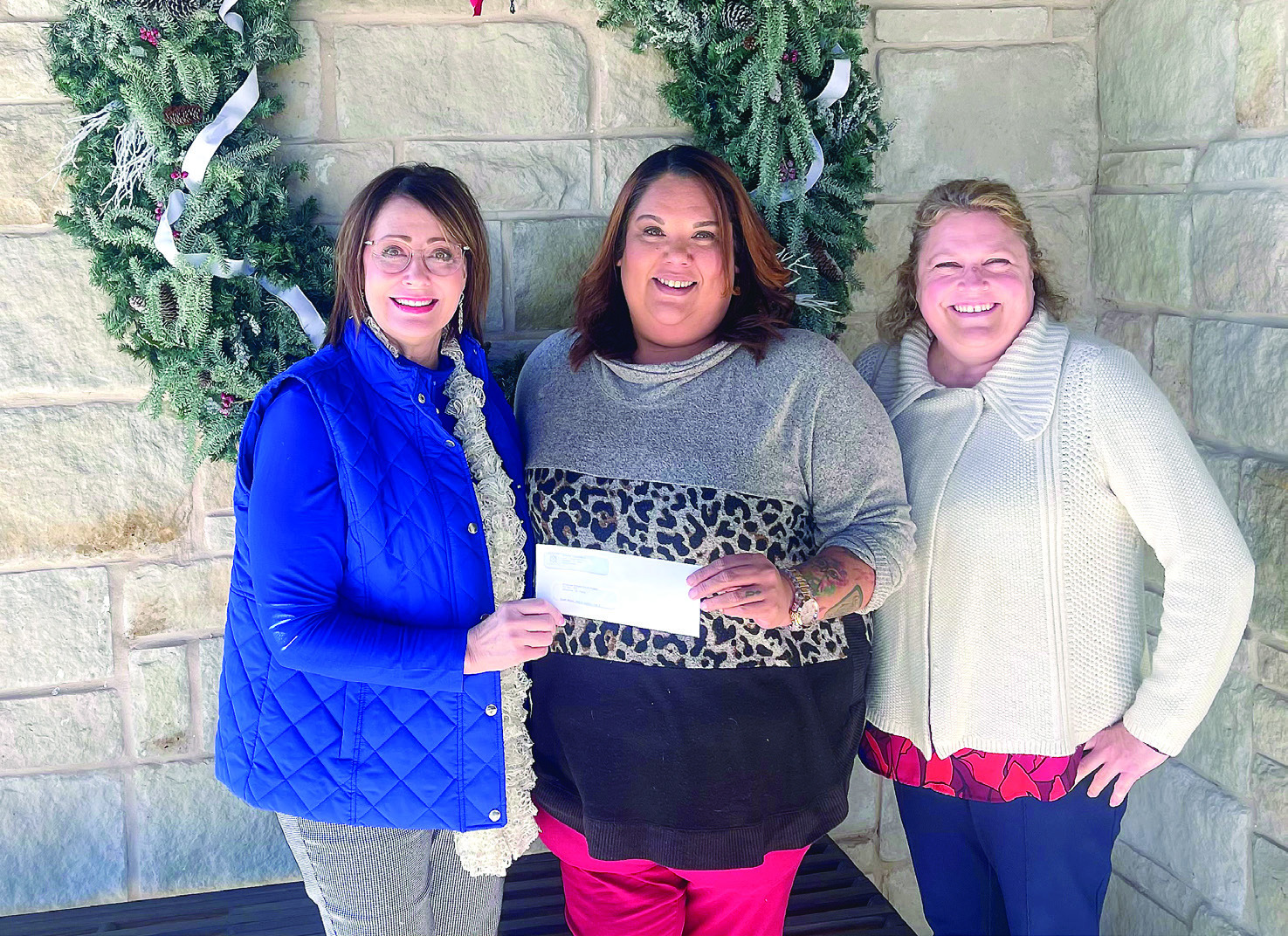 Kathy Laster, Ph.D. President &amp; CEO Avedis Foundation, presents a check to Tiffany Walker, Executive Director Shawnee Bridges Out of Poverty. Also pictured is Avedis Foundation Program Director Tracy Meeuswen. Photo provided
